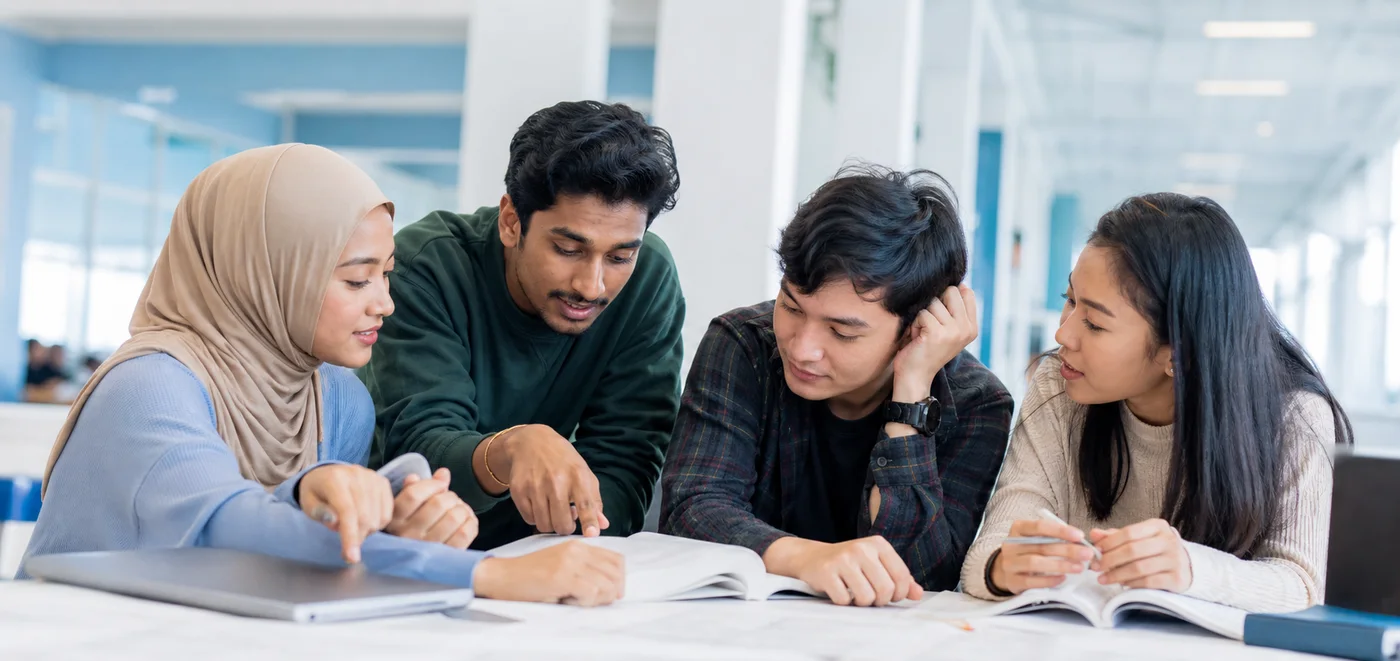 Multiracial Malaysian university students supporting one another with their studies